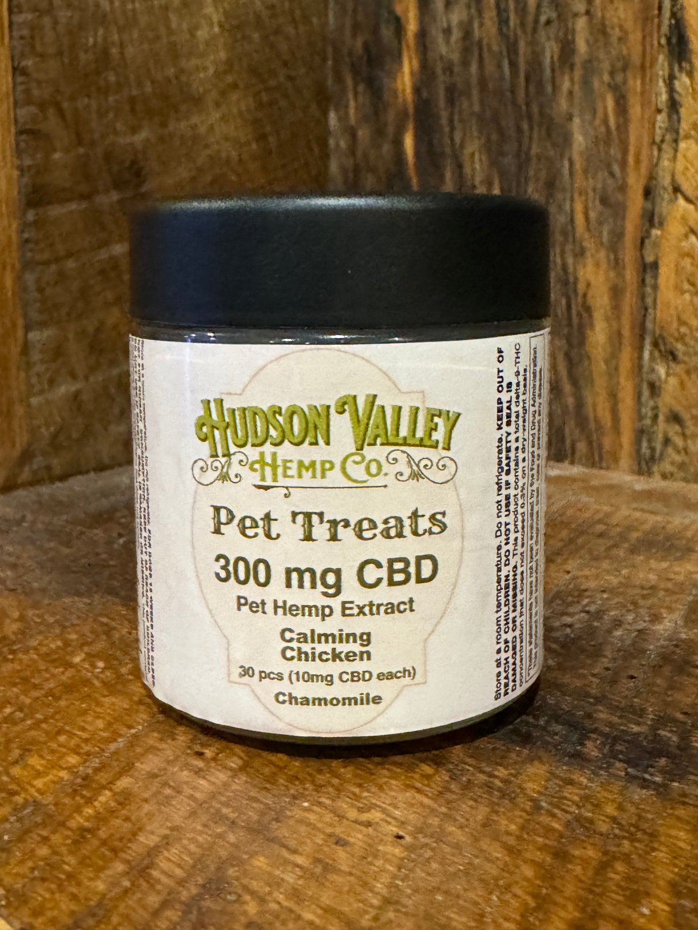 Jar of Hudson Valley Hemp Co. pet treats with 300 mg CBD on a wooden surface.